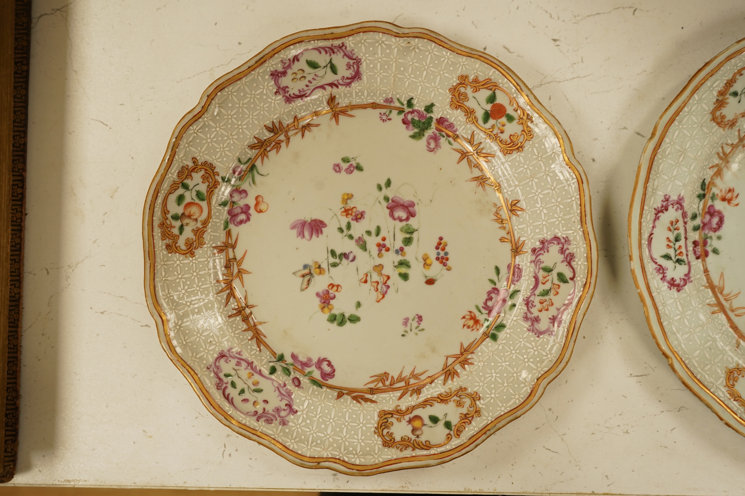 A pair of 18th century Chinese famille rose and bianco-sopra-bianco plates, 24cm